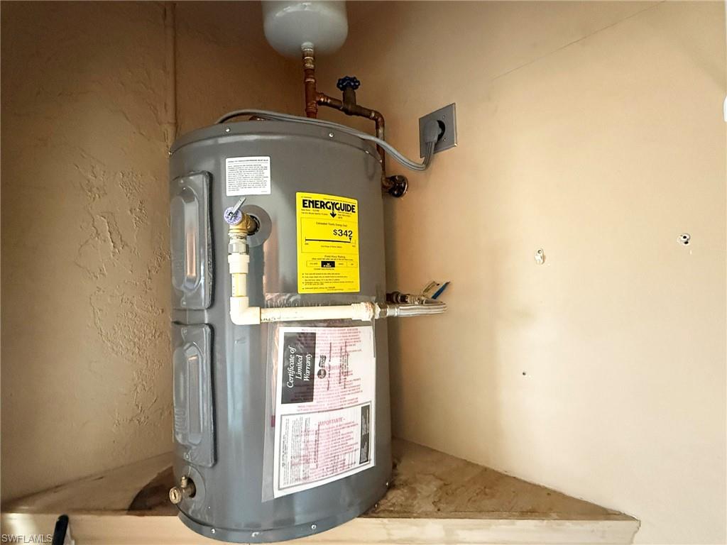 2005 Pine Isle Lane, Unit 2005 Naples, FL 34112 - Photo 14 of 23 Utility closet featuring a new water heater.