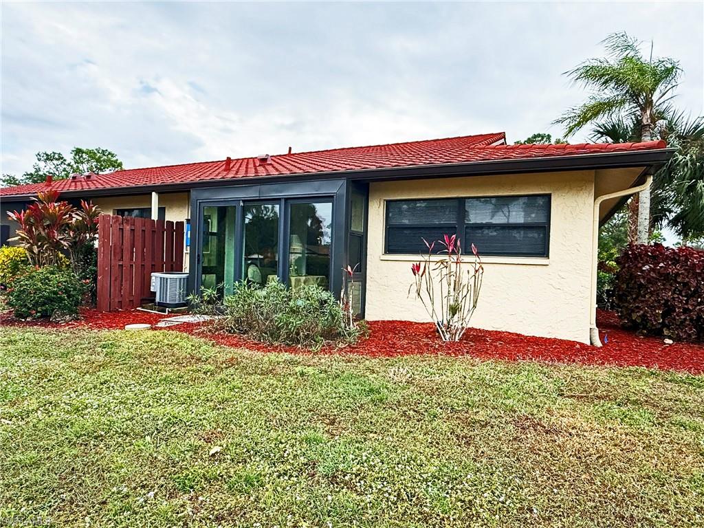 2005 Pine Isle Lane, Unit 2005 Naples, FL 34112 - Photo 16 of 23 Rear view of house showing enclosed Florida/Sunroom.