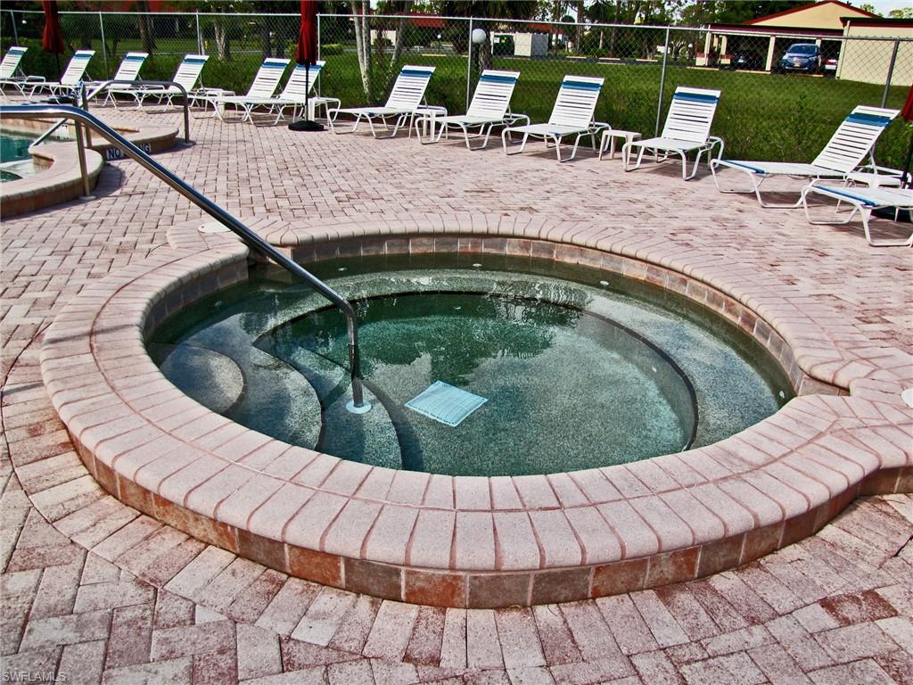 2005 Pine Isle Lane, Unit 2005 Naples, FL 34112 - Photo 21 of 23 Community hot tub/spa with paver deck.