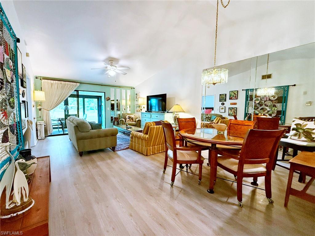 2005 Pine Isle Lane, Unit 2005 Naples, FL 34112 - Photo 6 of 23 Living area with high ceiling and wood-style flooring.