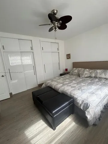 a bedroom with a bed and a ceiling fan