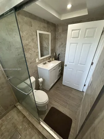 a bathroom with a sink toilet and mirror