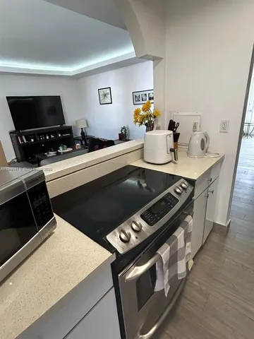 a stove top oven sitting inside of a kitchen
