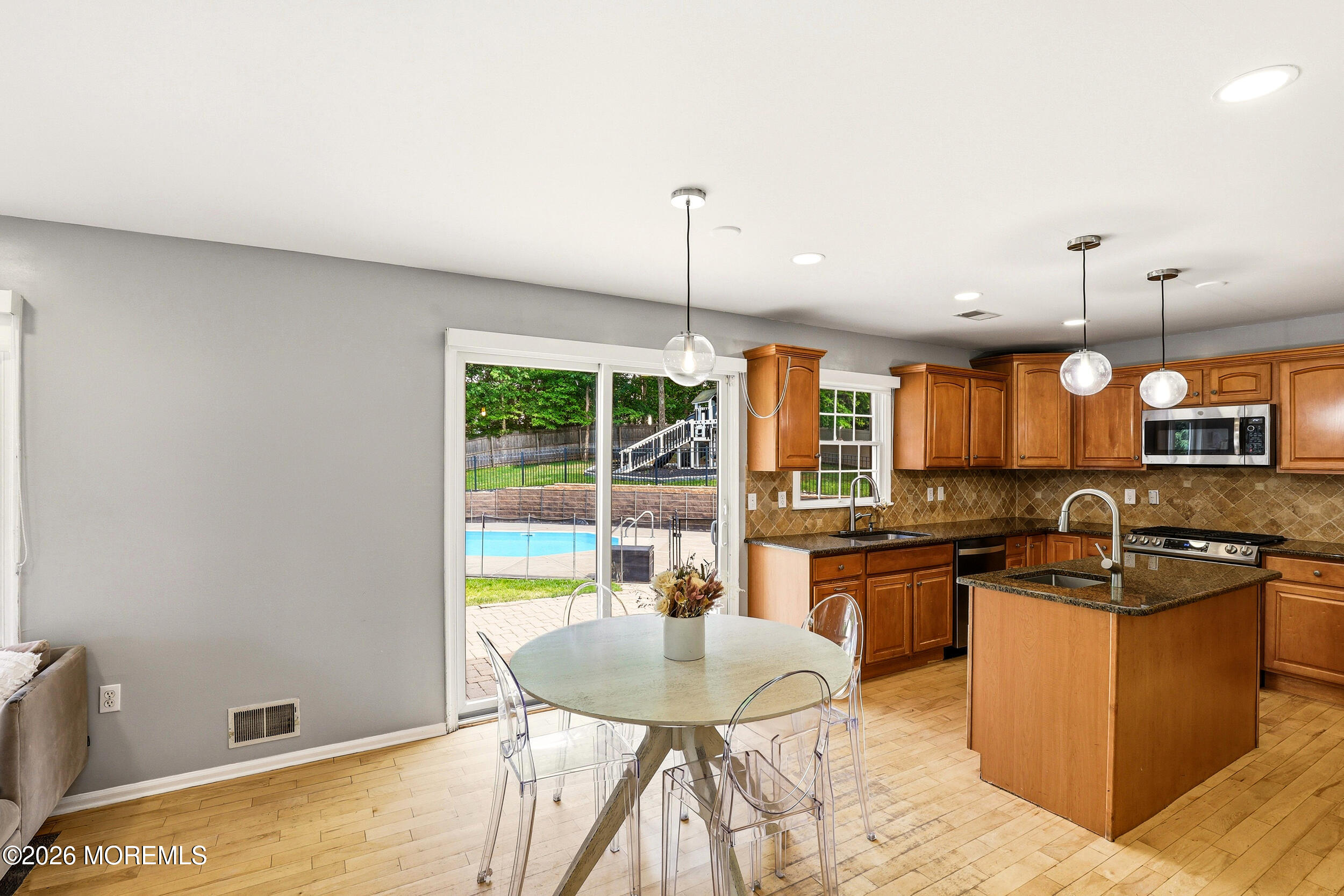 2055 MacKenzie Road Toms River, NJ 08755 - Photo 14 of 56 a kitchen with stainless steel appliances granite countertop a sink a stove and a wooden floors