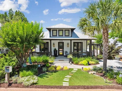 a front view of a house with garden and porch