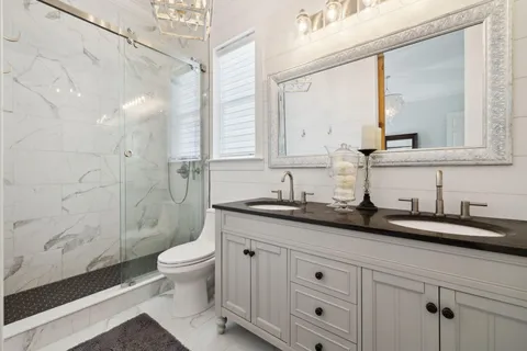 a bathroom with a sink a toilet and a mirror