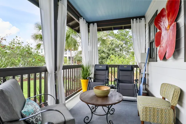 a view of a patio with couches table and chairs and potted plants