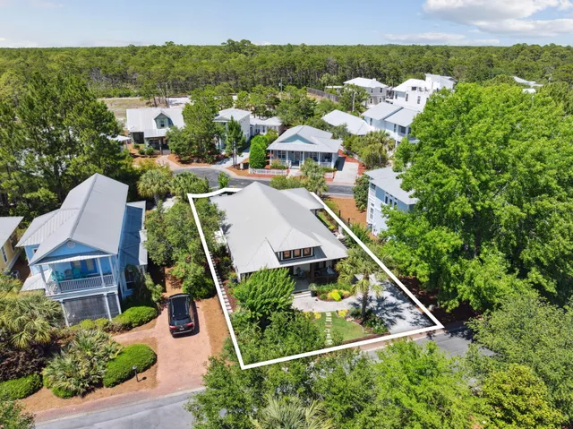 a view of a swimming pool with lawn chairs under an umbrella