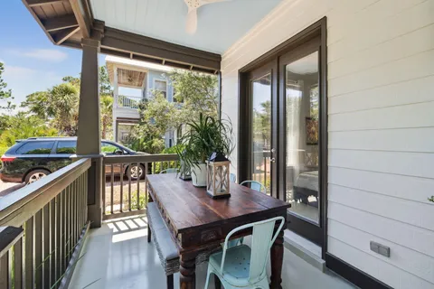 a view of a balcony dining table and chairs