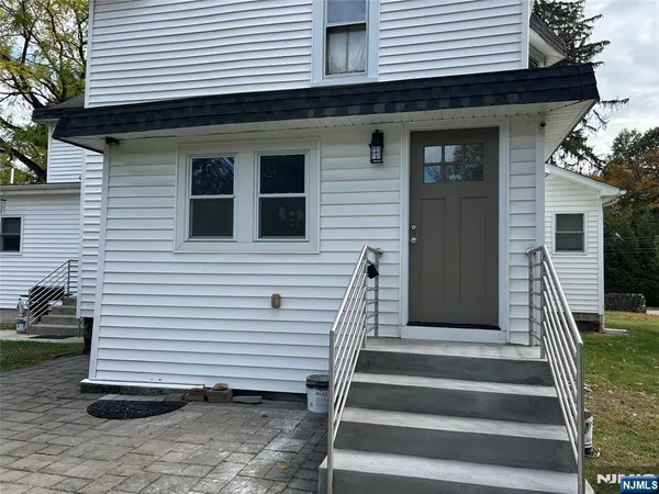 a view of a house with wooden deck