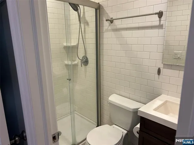 a bathroom with a toilet a sink and shower