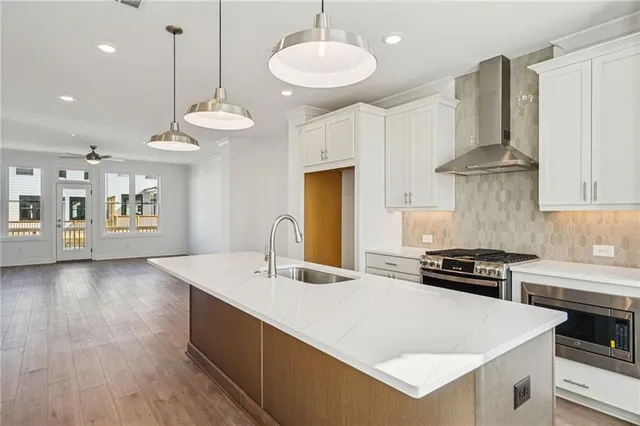 a kitchen with a stove and a white cabinets