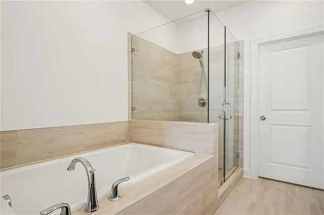 a bathroom with a tub and shower