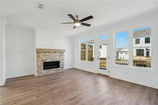 a view of empty room with wooden floor and fireplace