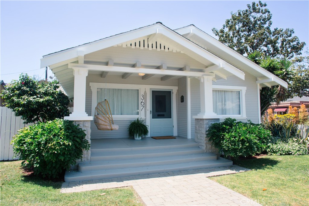 a view of a house with potted plants