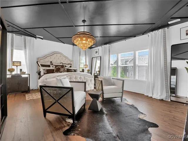 a view of a livingroom with furniture a rug a fireplace and windows