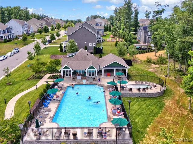 an aerial view of house with yard swimming pool and outdoor seating