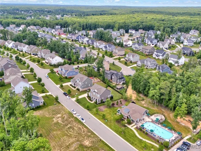 an aerial view of residential houses with outdoor space