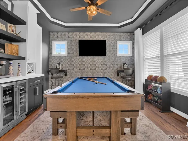 a room with furniture pool table and flat screen tv