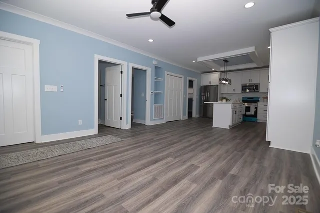 a view of a kitchen with a refrigerator and a stove top oven