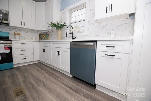 a kitchen with cabinets appliances and a counter space