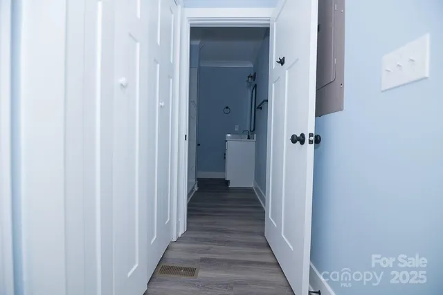 a view of a hallway with a wooden door