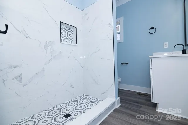 a bathroom with a shower and a sink