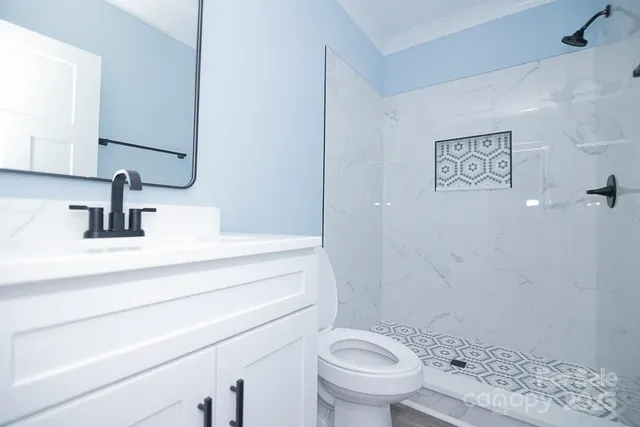 a bathroom with a sink a toilet and a mirror