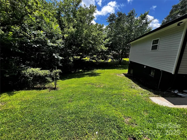 a view of backyard with swimming pool