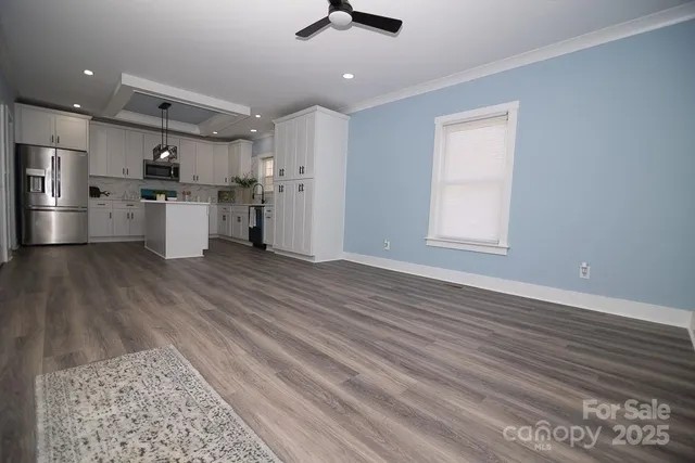 a view of kitchen with sink microwave and refrigerator