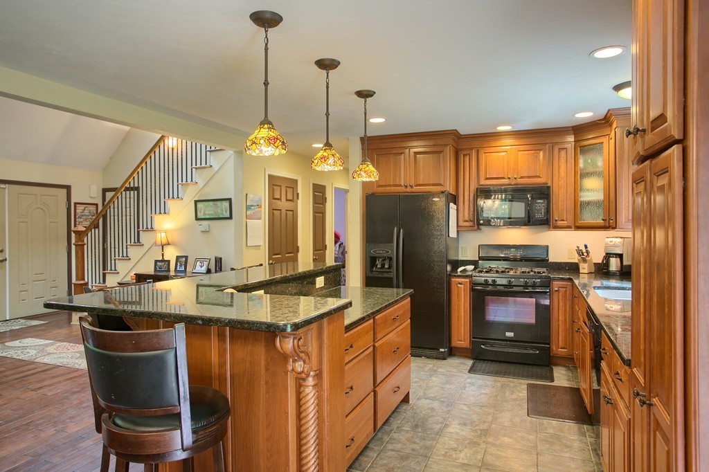 2270 South Athol Road Athol, MA 01331 - Photo 3 of 30 a kitchen with refrigerator a stove and chairs
