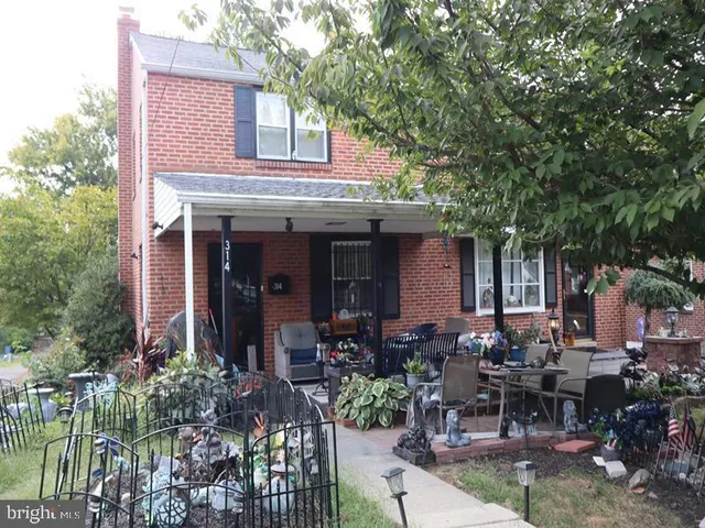a view of a house with sitting area and garden