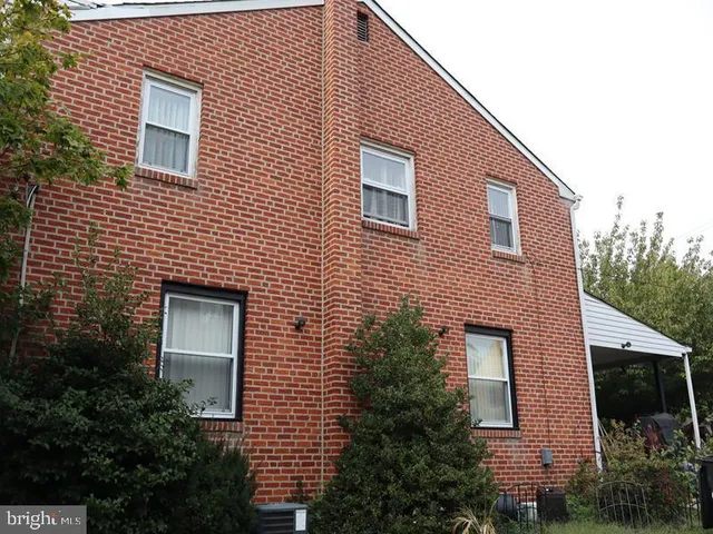 a front view of a house with plants