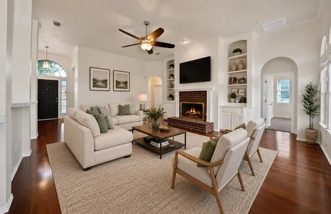 a living room with furniture fireplace and a flat screen tv