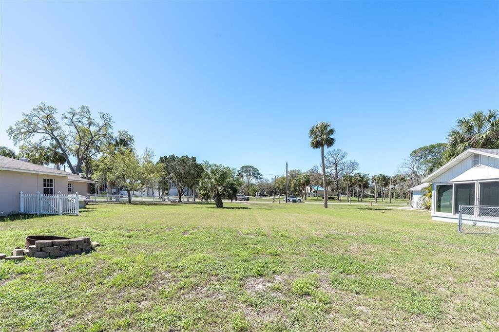 5433 Cotee River Drive New Port Richey, FL 34652 - Photo 11 of 18 a view of a big yard with a house