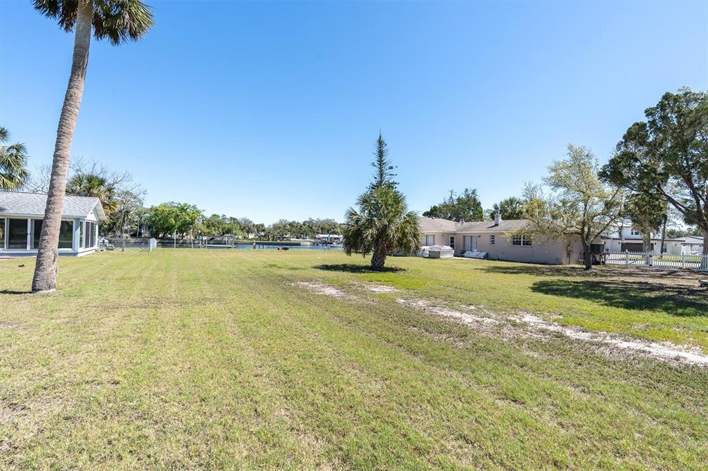 5433 Cotee River Drive New Port Richey, FL 34652 - Photo 12 of 18 a view of swimming pool with seating area and trees around