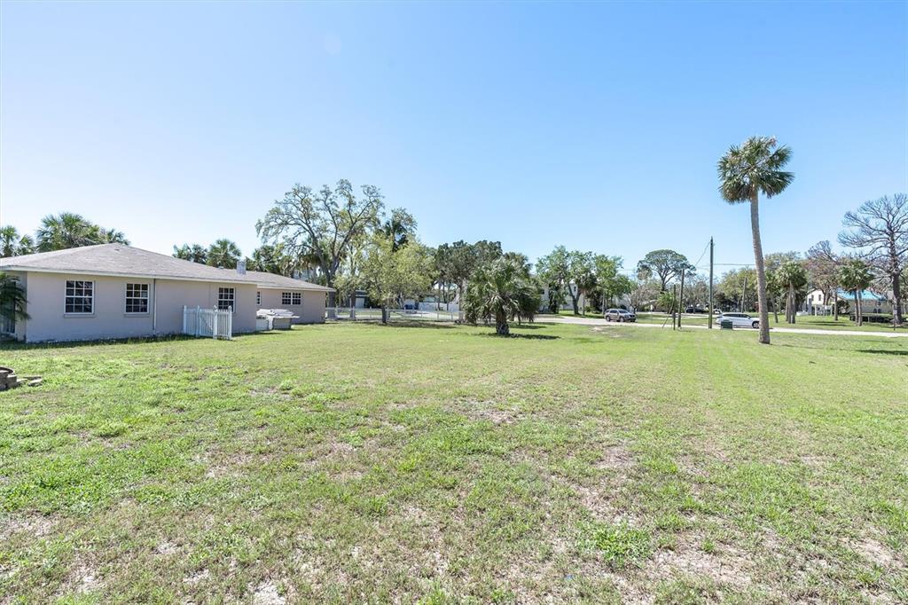 5433 Cotee River Drive New Port Richey, FL 34652 - Photo 13 of 18 a front view of a house with a yard and trees
