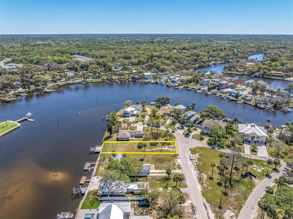 5433 Cotee River Drive New Port Richey, FL 34652 - Photo 18 of 18 an aerial view of a house with a lake