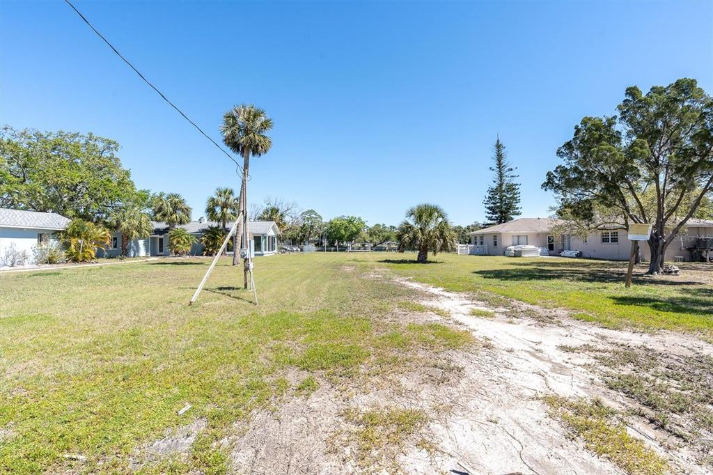 5433 Cotee River Drive New Port Richey, FL 34652 - Photo 10 of 18 a view of a swimming pool with a yard