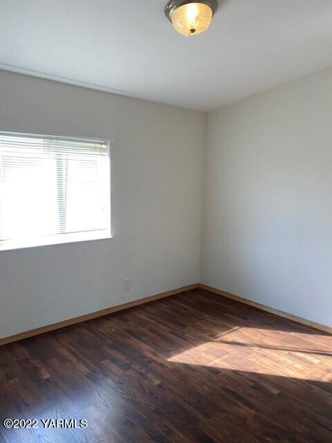 15472 Summitview Road Cowiche, WA 98923 - Photo 13 of 15 a view of an empty room with wooden floor and a window