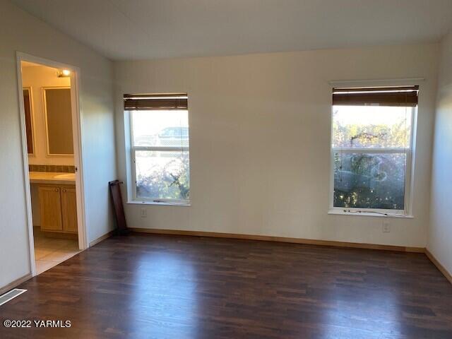 15472 Summitview Road Cowiche, WA 98923 - Photo 8 of 15 a view of an empty room with wooden floor and a window