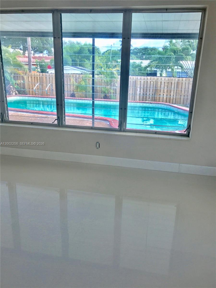 3700 Taft Street Hollywood, FL 33021 - Photo 3 of 10 a view of empty room with large window