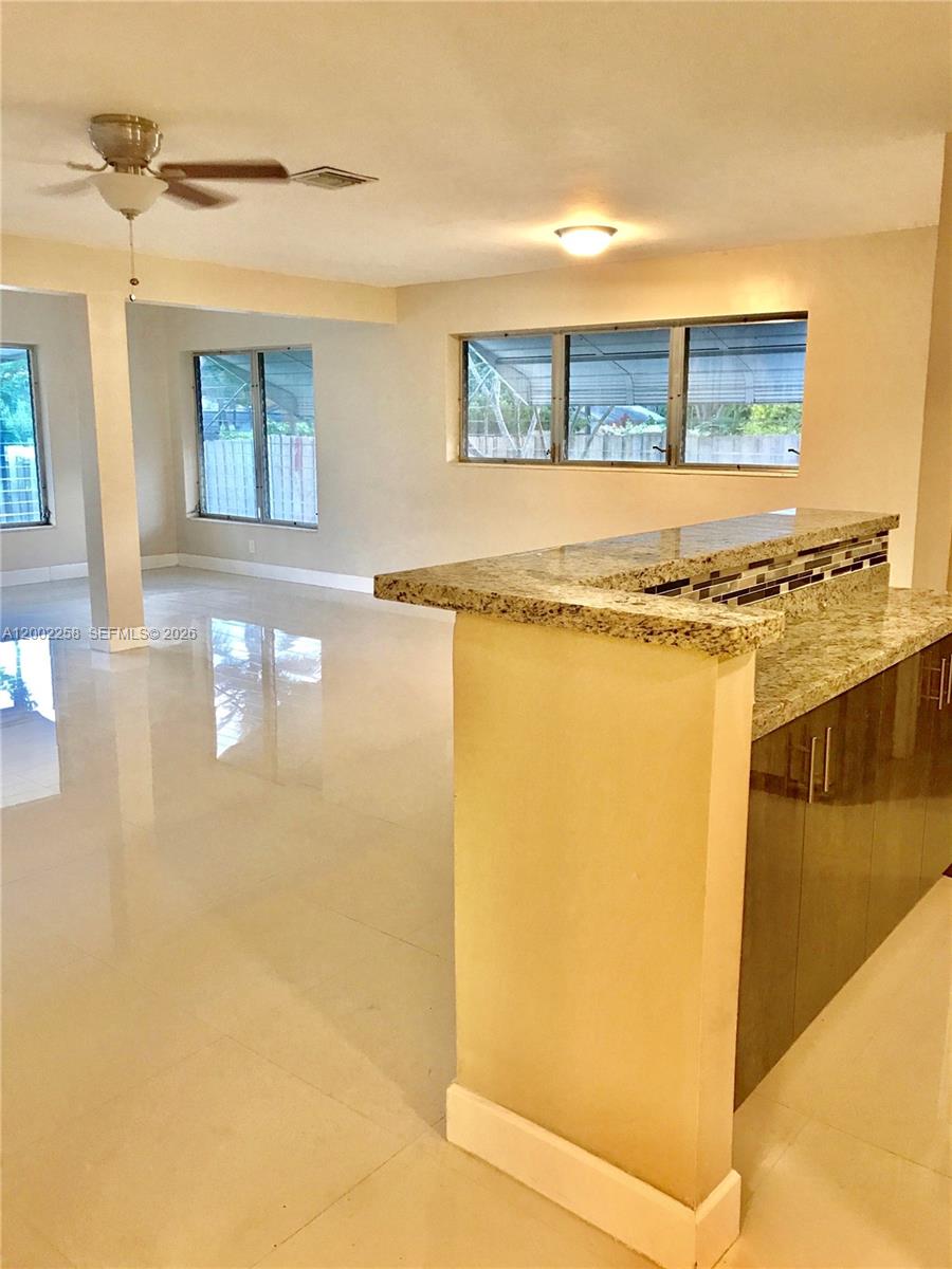 3700 Taft Street Hollywood, FL 33021 - Photo 6 of 10 a view of a kitchen with a refrigerator