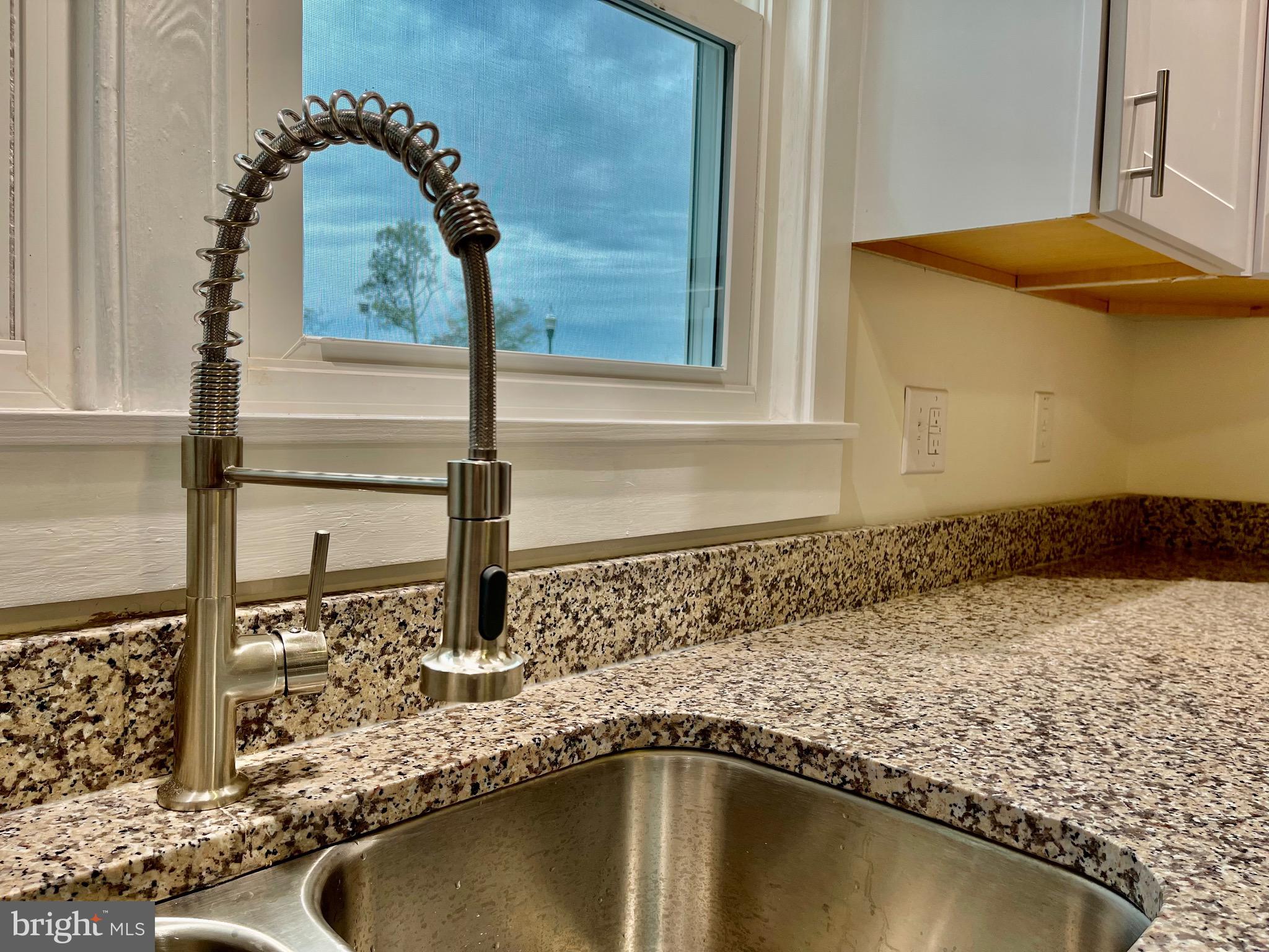 26540 Deal Island Road Princess Anne, MD 21853 - Photo 25 of 76 a bathroom with a granite countertop sink and a mirror