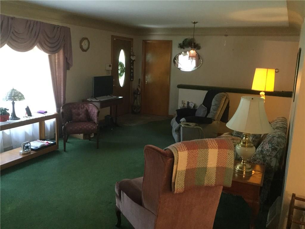 LIVING ROOM FEATURES HARDWOOD FLOORS, PLASTERED WALLS WITH COVE CEILINGS.