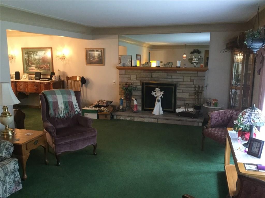 THE LIVING ROOM IS OPEN TO THE DINING ROOM AND IT FEATURES A GAS FIREPLACE.