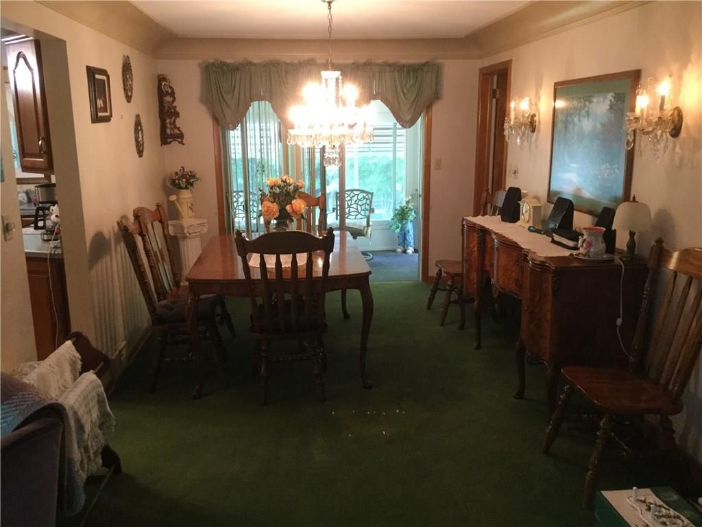 FORMAL DINING ROOM LEADS TO THE KITCHEN, THE DEN AND THE SUNROOM. 