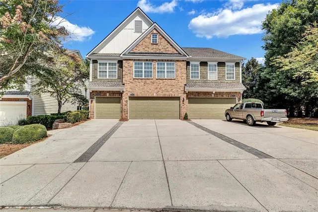 a car parked in front of a house with a yard