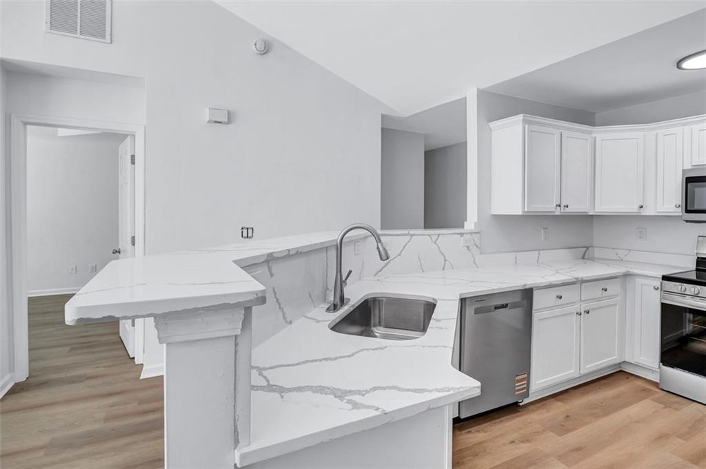 2540 Willow Grove Road, Unit 15 Acworth, GA 30101 - Photo 5 of 35 a kitchen with a sink cabinets and wooden floor
