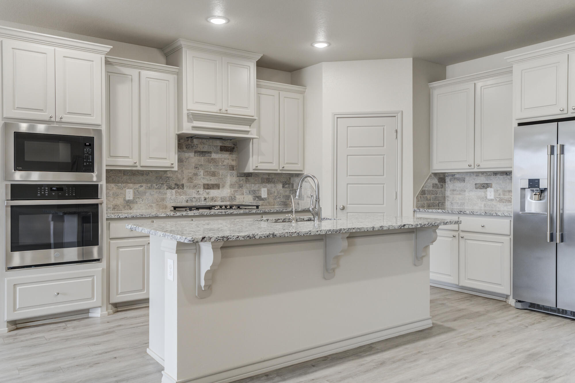 7614 62nd Street Lubbock, TX 79407 - Photo 13 of 54 a kitchen with stainless steel appliances granite countertop a stove a sink and a refrigerator